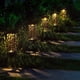 thumbnail image 3 of Lámparas solares de jardín con diseño hueco, iluminación cálida, impermeables y energizadas por panel solar. Ideal para exteriores, encienden automáticamente al anochecer. Disponible en sets de 2, 4,, 3 of 7