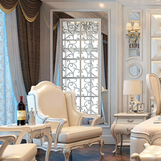 EGNMCR Wall Stickers, a set of 16 DIY acrylic mirror decal mural wall stickers in a silver finish, displayed in an elegant living room setting. The stickers feature intricate scrollwork patterns and are applied to a smooth surface, creating a decorative and reflective effect. Suitable for walls, doors, and furniture, these removable decals are ideal for enhancing home decor with a modern and stylish touch.