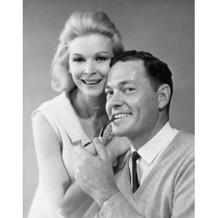 Woman Smoking Pipe Portrait of a mid adult man smoking a pipe and a mid adult woman standing beside him Canvas Art - (18 x 24) ()