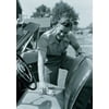 Man cleaning seat of convertible car Poster Print