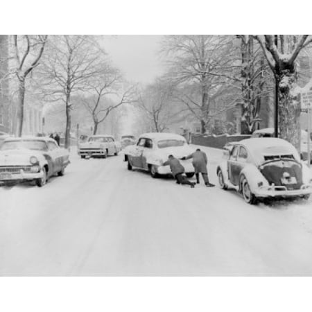 Men pushing car down snow-covered street Canvas Art -  (24 x