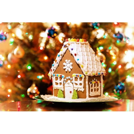 - Homemade Christmas Gingerbread House Displayed on a Table. Christmas Tree Lights in the Background. Print Wall Art By Leena Robinson