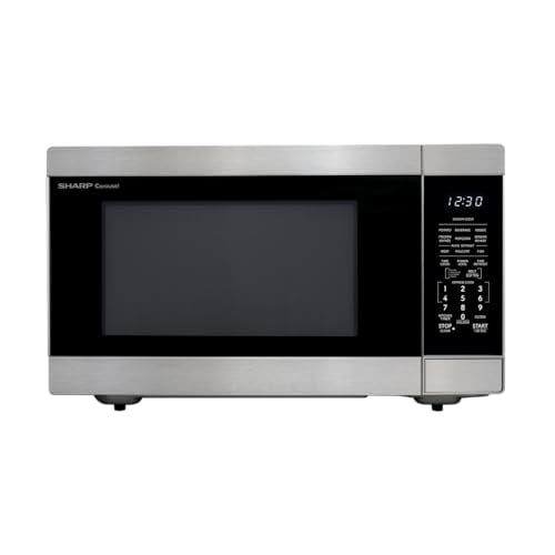 horno microondas de encimera Sharp SMC2266KS, 2.2 pies cúbicos, acero inoxidable con plato giratorio extraíble de 16.5"; vista frontal centrada con puerta de vidrio, panel derecho con pantalla LED blanca y controles One-Touch, iluminación interior LED y acabado cepillado; adecuado para porciones grandes y también usado para calentar bandejas de servicio.
