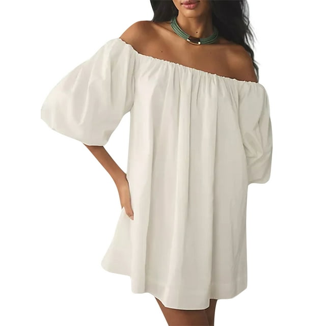 Gupgi Women Puff Sleeve Mini Dress featuring an off-shoulder design with pleated detailing and lantern sleeves. This loose, casual sundress is made of 100% elastane in a solid white color. The dress is styled for summer occasions such as beach outings, cocktail parties, or casual gatherings. Shown in a front-facing view with a model wearing a green necklace.