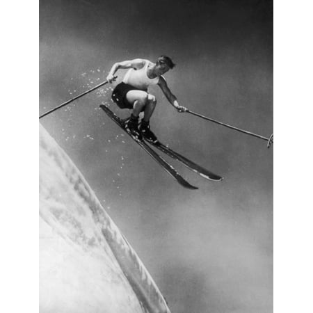 Man in a Vest in Mid-Air as He Skis Down a Steep Mountain Print Wall