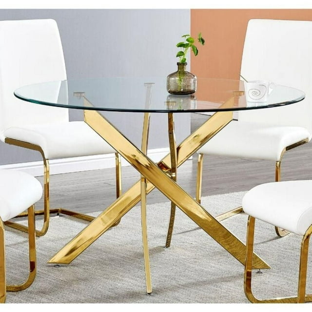 36-inch round glass dining table featuring a shiny gold metal star base, surrounded by white cushioned chairs with matching gold legs.