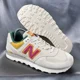 thumbnail image 1 of New Balance 574 Sneakers Men's 9D / Women's 10.5D Pink Cream ML574TS Casual Shoe, 1 of 6