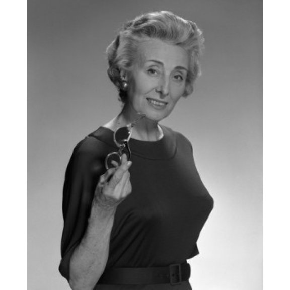 Portrait of smiled old woman holding glasses studio shot Canvas Art -  (24 x 36)