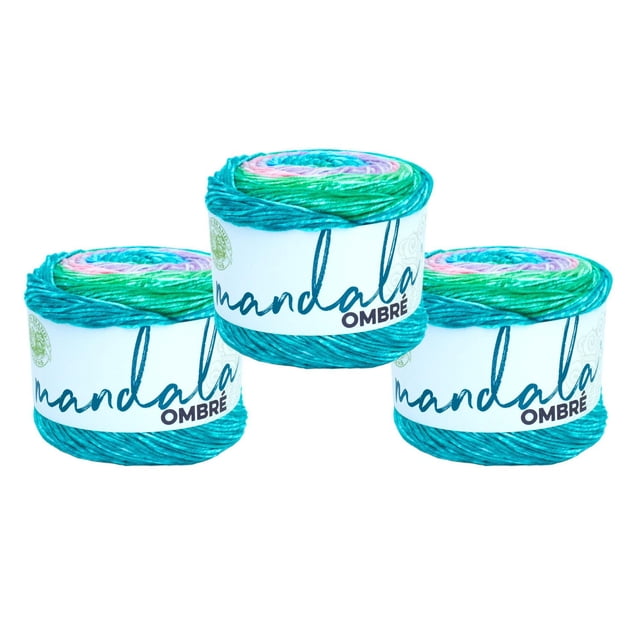 Lion Brand Mandala® Ombre Yarn #4 Medium/Worsted Yarn 150g/315m 3-Pack showing three skeins of acrylic yarn with a gradient blend of teal, green, purple, and pink, each wrapped with a white label featuring the Mandala Ombre logo, suitable for knitting, crochet, and colorful craft projects.