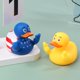 thumbnail image 2 of Pato de goma con forma de dedo medio, pato de goma con forma de Trump, con patrón de bandera de EE. UU., pato amarillo pequeño para el interior del tablero de instrumentos del automóvil y la camioneta, 2 of 5