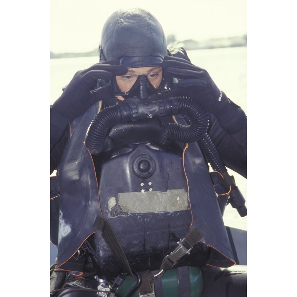 A Navy SEAL combat swimmer adjusts his dive mask Poster Print (11 x 17