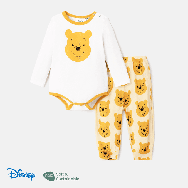 disney disney winnie the pooh conjunto de mono de mangas largas con estampa de personaje y pantalones naia™ para bebé (niña/niño) de 2 piezas Conjunto de ropa de bebé: body blanco de mangas largas con ribete mostaza y gran estampado frontal de la cara de Winnie the Pooh, pantalón beige claro con estampado repetido de la misma cara, botones de presión en hombro y entrepierna, tejido Naia™ ligero; fondo de estudio. También apto para sesiones de fotos de recién nacido.