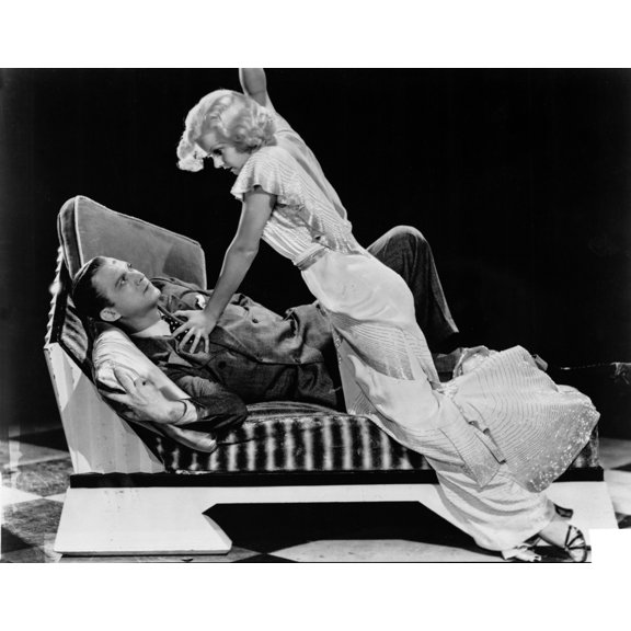 Jean Harlow Scene from a Film Knelt on the Couch in White Ruffled Short Sleeve Silk Dress with Frilled Skirt Photo Print (24 x 30)