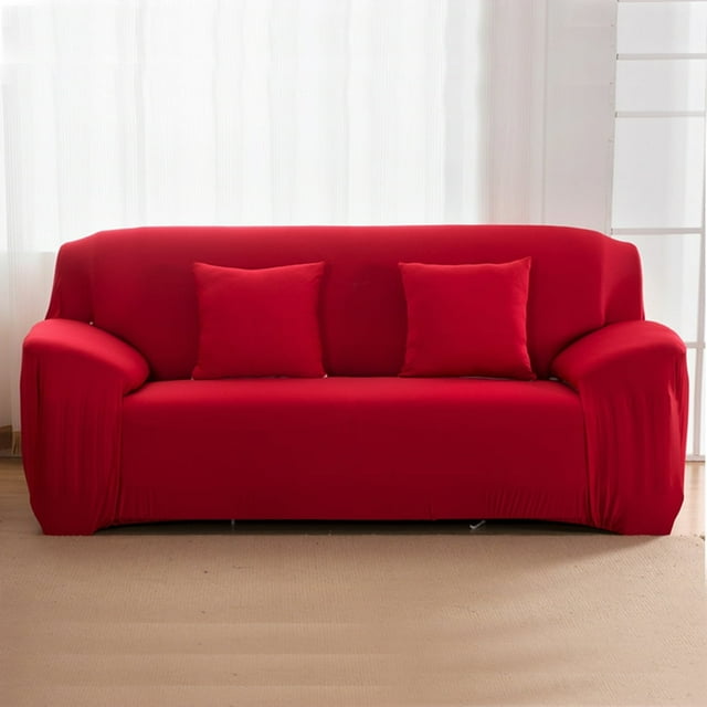 JUNWELL Housse de Sofa Slipcover Extensible Élastique en Rouge Vif, Conçue pour les Canapés 1/2/3/4 Places. Fabriquée en 85 % polyester et 15 % Élasthanne, Cette Housse de Sofa Extensible Est durable, Respirante et Présente des Coins Élastiques Intégrés pour un Ajustement Serré. Idéale comme Protecteur de Meubles contre les Déversements et l'Usure, Elle Est Lavable à la machine et Facile à Installer. la Slipcover Est Exposée sur un Sofa Trois Places dans une Pièce Minimaliste avec un Tapis beige et des Rideaux Blancs.
