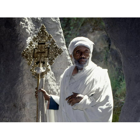 Old Ethiopian Orthodox Priest Holds a Large Brass Coptic Cross at Rock-Hewn Church of Adadi Maryam Print Wall Art By Nigel