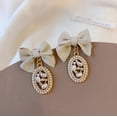thumbnail image 3 of Clip on 1 1/2" gold, tan bow, and pearl edge dangle earrings, 3 of 4