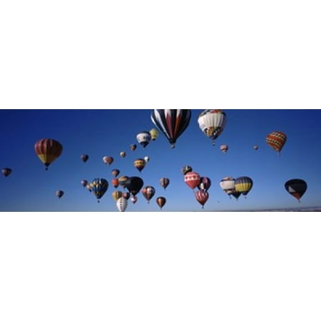 Albuquerque International Balloon Fiesta (Hot air balloons floating in sky Albuquerque International Balloon Fiesta Albuquerque Bernalillo County New Mexico USA Stretched Canvas - Panoramic Images (18 x)