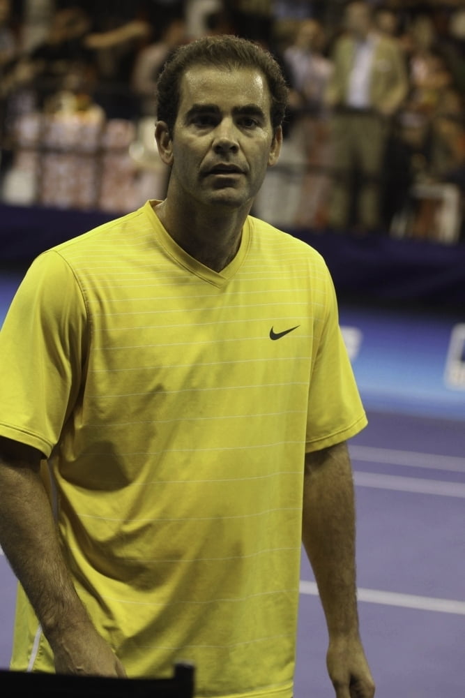 Pete Sampras wearing a yellow t-shirt 