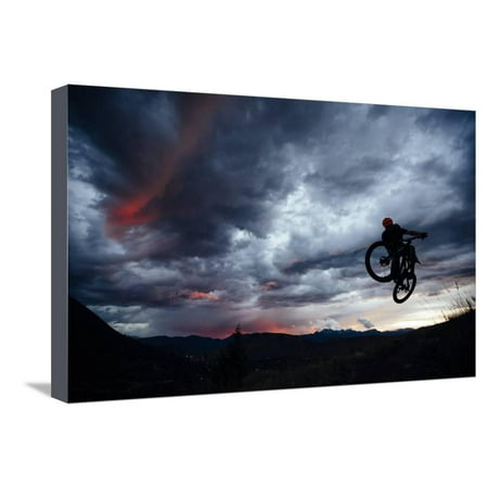 - Mountain Biker Gets Air While Riding Teton Singletrack As A Summer Thunderstorm Highlights Sunset Stretched Canvas Print Wall Art By Jay Goodrich
