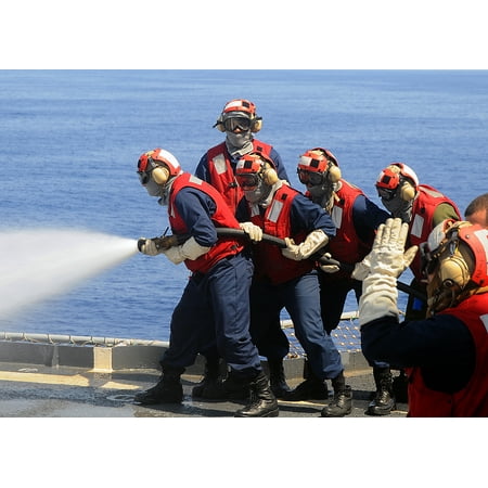 Team Practice Drills LAMINATED POSTER Sailors from the flight deck firefighting team practice firefighting techniques during drills held Poster Print 24 x 36 ()
