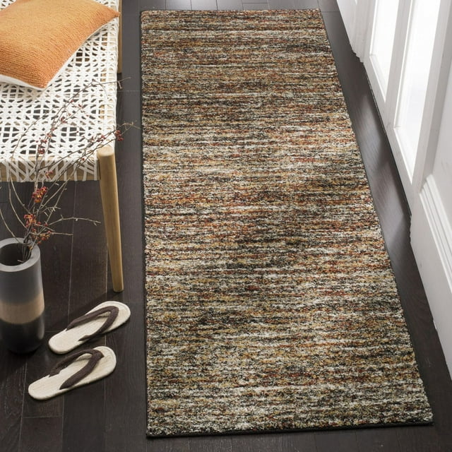 SAFAVIEH Retro Gorica abstract area rug in earthy tones of brown, beige, and rust on dark hardwood floor beside white woven bench with orange pillow.
