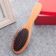 thumbnail image 5 of Peine de madera de Higo con almohadilla de aire para masaje capilar, diseño ergonómico y púas negras circulares. Ideal para cuidado del cabello y reducción de estática., 5 of 6