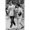 thumbnail image 2 of Consumers-A Couple Strolls In Tokyo Wearing U.S. Football Shirts. 62375 - Cpl ArchivesEverett Collection History (, 2 of 2