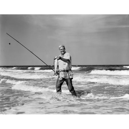 1950s Older Man Standing In Surf In Waders Holding Fish In One Hand Fishing Pole In Other Print By Vintage