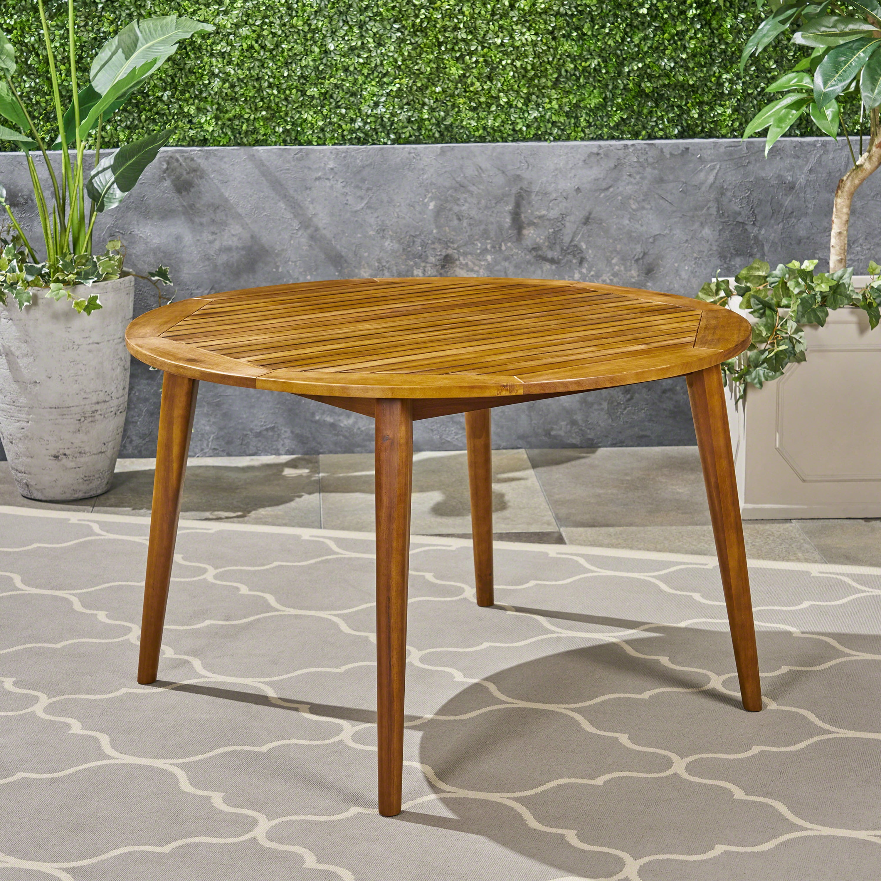 Euroco simple and sleek acacia wood dining table is the perfect addition to any backyard space