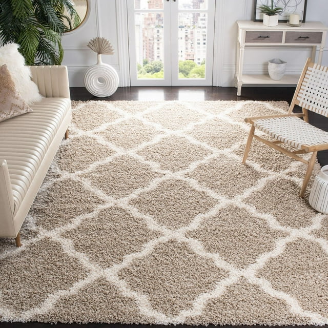 Beige Safavieh Dallas Logan shag area rug featuring a white geometric diamond pattern in a bright living room with cream sofa and wooden chair.