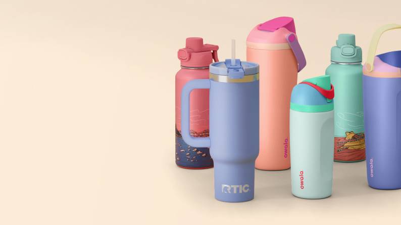 Pastel water bottles on a beige background.