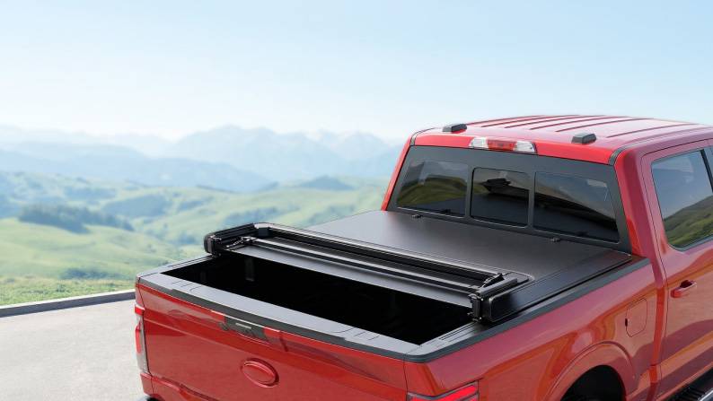 A red truck showcasing a truck bed cover.
