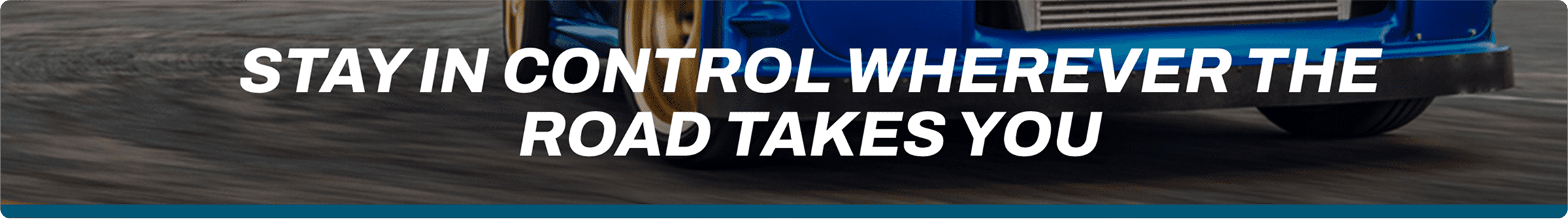 A shot of a car on a racetrack with the text Stay In Control Wherever The Road Takes You.