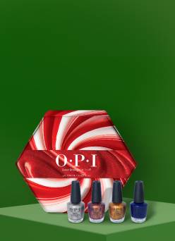 OPI nail polish is seen in front of an OPI gift box. There are four nail polishes in different colors.