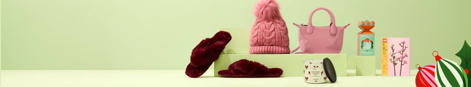 An image of slippers, pink hat, pink handbag, Mainstays candle, Bubble gift set and a LEGO set.