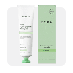 Image shows Boka fluoride-free nano hydroxyapatite toothpaste in Ela Mint flavor, with a white tube and green packaging on a light background.