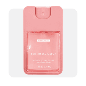 Image shows a pink rectangular bottle of Scent Theory Sun-Kissed Melon moisturizing spray hand sanitizer on a light gray background.