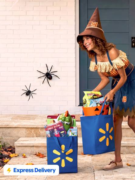 Express Delivery badge. Adult in scarecrow costume brings Walmart grocery bags to a porch with Halloween decorations.