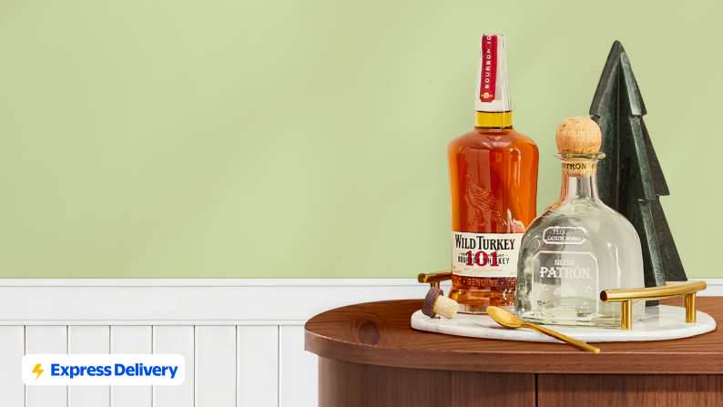 Express Delivery. A bottle of Wild Turkey 101 Kentucky Straight Bourbon, a bottle of Patrón silver tequila, and a decorative evergreen tree.