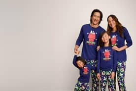 From fifteen dollars. A family of four wearing matching Snoopy pajamas is pictured on a beige backdrop.