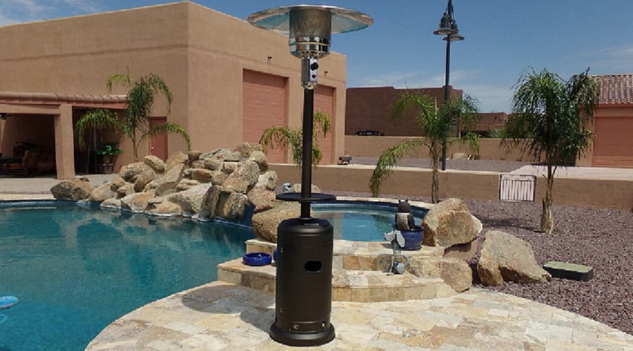 A standing patio heater by a pool