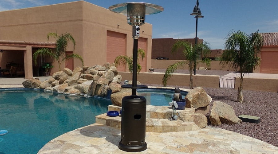 A standing patio heater by a pool