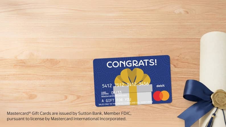 A gift card next to a diploma.