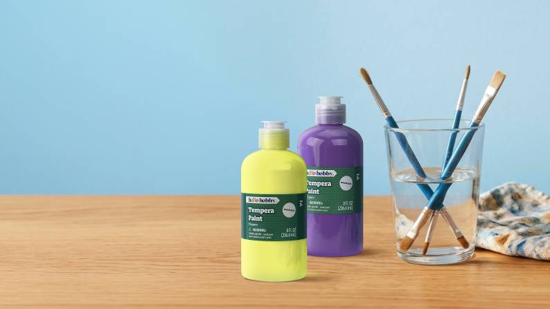 Blue banner image with a crafting table and paint supplies with text: For your next creation. Paint with Hello Hobby. Shop now.