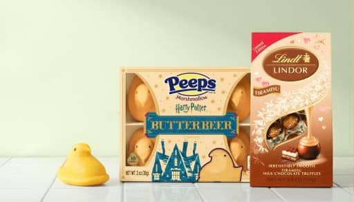 A single marshmallow peep next to a pack of Harry Potter butterbeer Peeps and a package of Lindt Lindor tiramisu truffles.