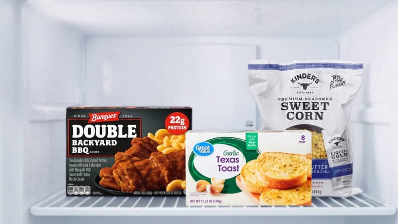 A Banquet double backyard BBQ meal, Great Value garlic Texas toast and Kinder’s premium seasoned sweet corn in a freezer.