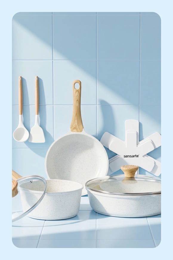 View a set of white kitchen pots, pans and tools with wooden handles.