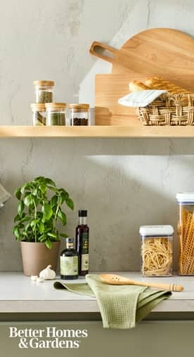 Better Homes & Gardens logo. A kitchen counter and shelf shown with multiple food jars and kitchen tools.