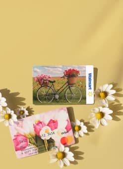 Floral-patterned gift cards on a yellow background, surrounded by daisies.