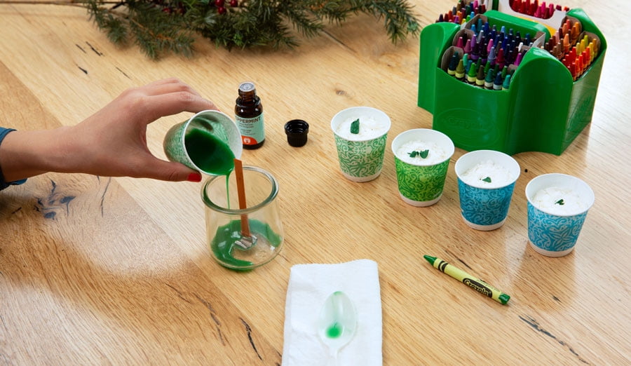 Pouring first layer of tinted wax to make a layered candle